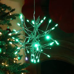 Alpine Corporation 10"H Indoor Christmas Twig 3D Hanging Snowflake Ornament with LED Lights, Green